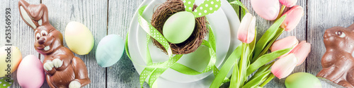 Easter holiday table setting with rabbits and eggs