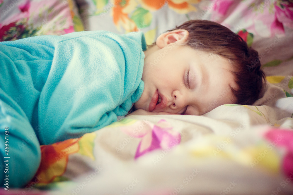 the boy is sleeping. little baby is sleeping sweet sleep baby. boy in a blue fleece suit the boy is sleeping. little baby is sleeping sweet sleep baby. boy in a blue fleece suit