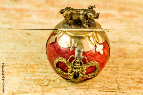 acupuncture needle on antique Chinese paperweight