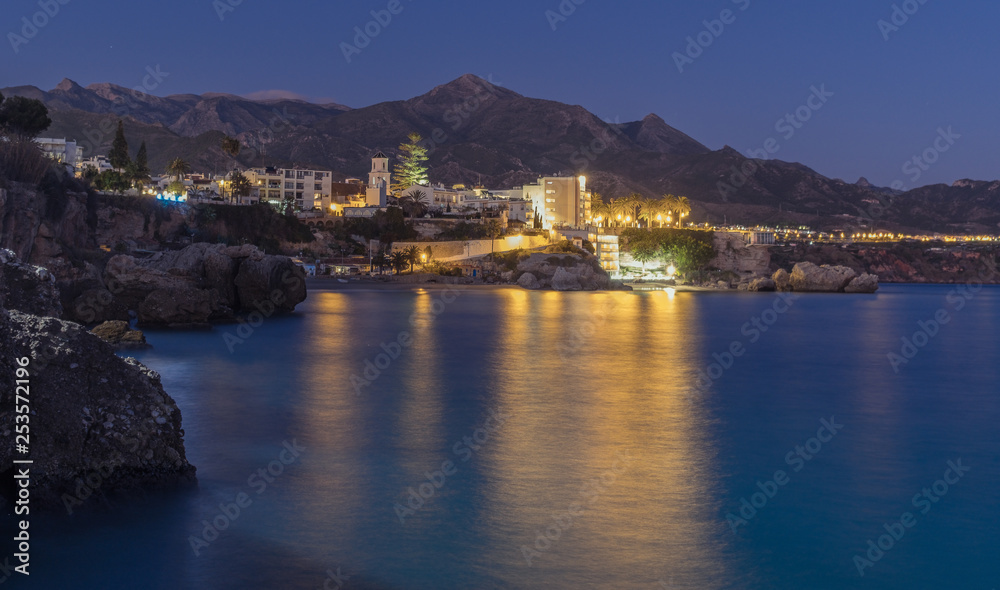 Nerja, Malaga, Andalusi, Spain - January 21, 2019: Moon at the beginning of the night over the coastal town of Nerja, southern Spain