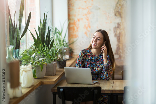 Young woman with laptop in cafe