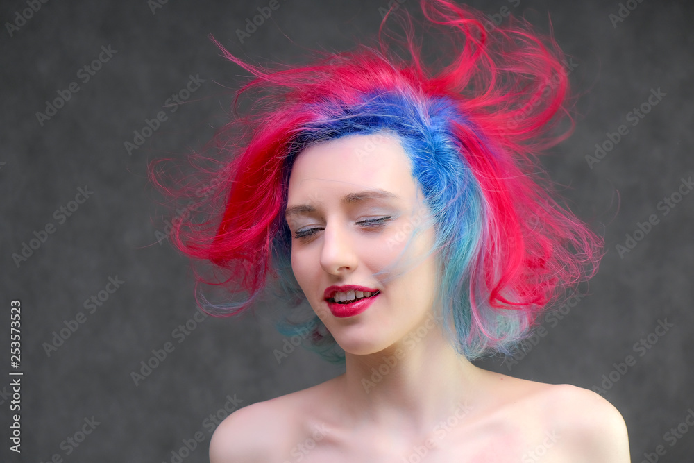Naklejka premium High fashion model woman with multi-colored hair posing in the studio, portrait of a beautiful sexy girl with a fashionable makeup.