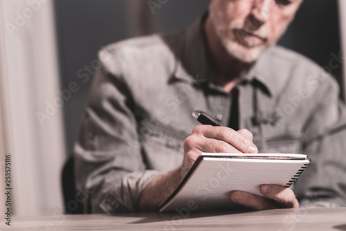 Man taking notes on a notebook