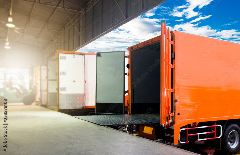 Cargo Container Trucks Parked Loading at Dock Warehouse. Shipment