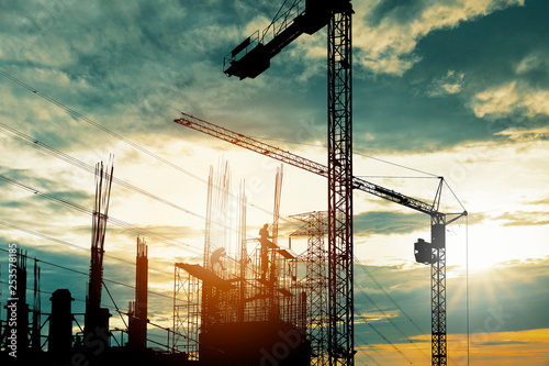 Konstfotografi Silhouette of crane construction building towers at sunset