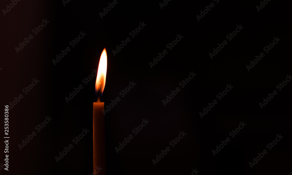 simple background pattern one soft focus candle in dark environment with empty copy space for your text or inscription, pray or mourning concept photography