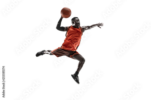 Full length portrait of a basketball player with a ball isolated on white studio background. advertising concept. Fit african anerican athlete jumping with ball. Motion, activity, movement concepts. © master1305