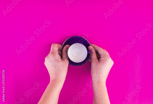 Woman hands holding a empty cup on isolated background