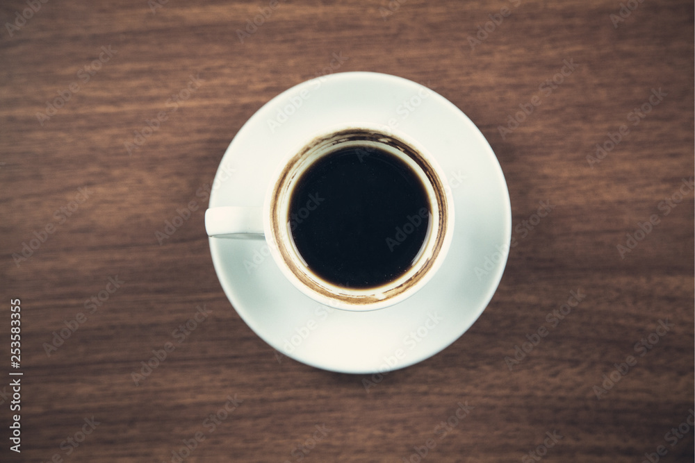 White coffee cup on a wooden desk. White coffee cup on a wooden desk.