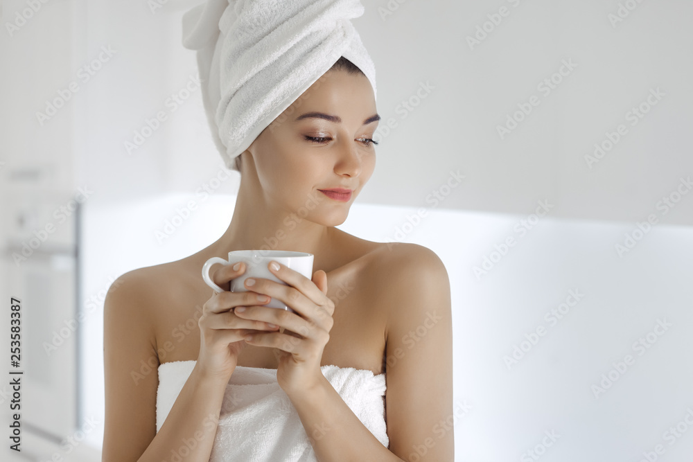 Young woman in towel enjoying coffee at home. Young woman in towel enjoying coffee at home.
