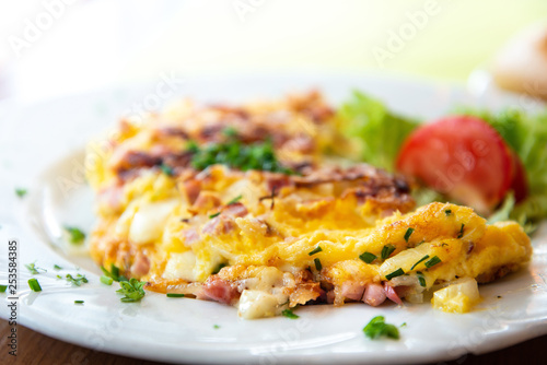 omelet with ham tomato and green salad photo
