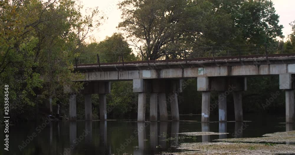 Static shot of an old train bridge on the San Marcos River on a long lens.