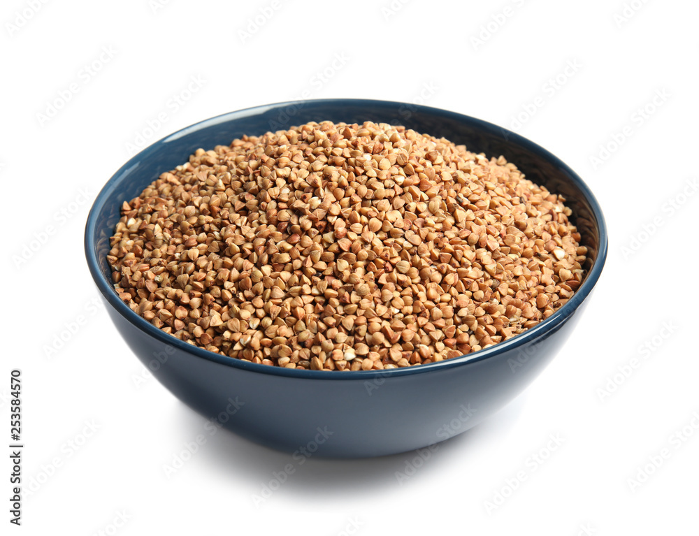 Bowl with uncooked buckwheat on white background Bowl with uncooked buckwheat on white background