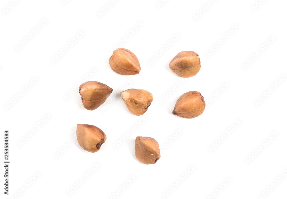 Uncooked buckwheat on white background, top view Uncooked buckwheat on white background, top view
