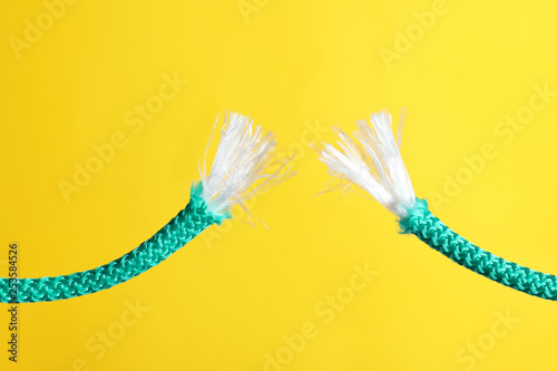 Rupture of blue rope on color background