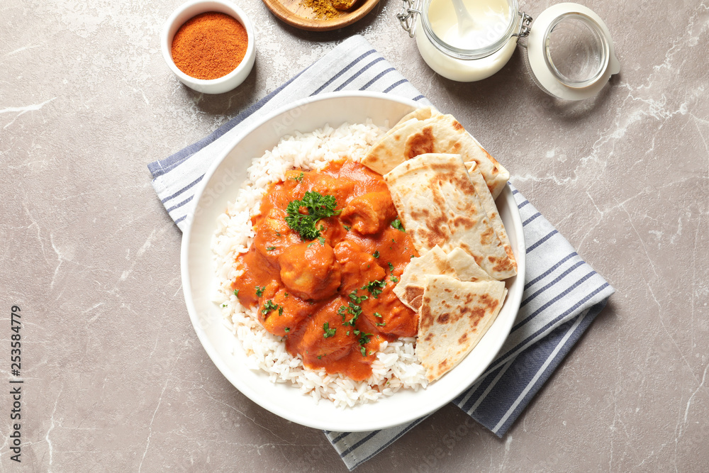 Delicious butter chicken with rice served on table, flat lay Delicious butter chicken with rice served on table, flat lay