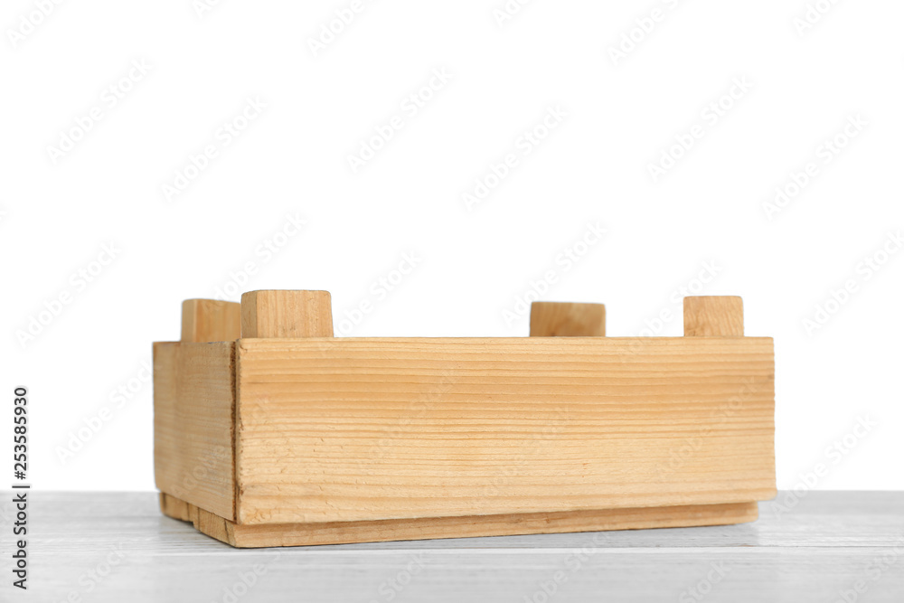Empty rustic wooden crate on table against white background Empty rustic wooden crate on table against white background