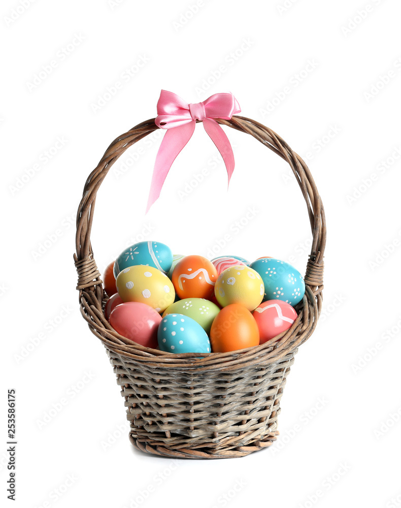 Wicker basket with painted Easter eggs on white background Wicker basket with painted Easter eggs on white background