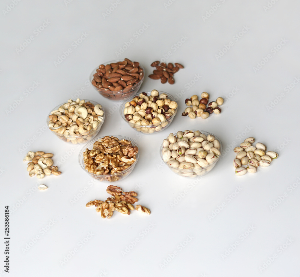 Healthy food. Nuts mix assortment on stone table top view. Collection of different legumes for background image close up nuts, pistachios, almond, cashew nuts, peanut, walnut. image