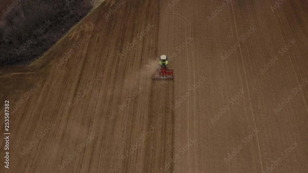 Big tractor harrowing a ploughed field Big tractor harrowing a ploughed field