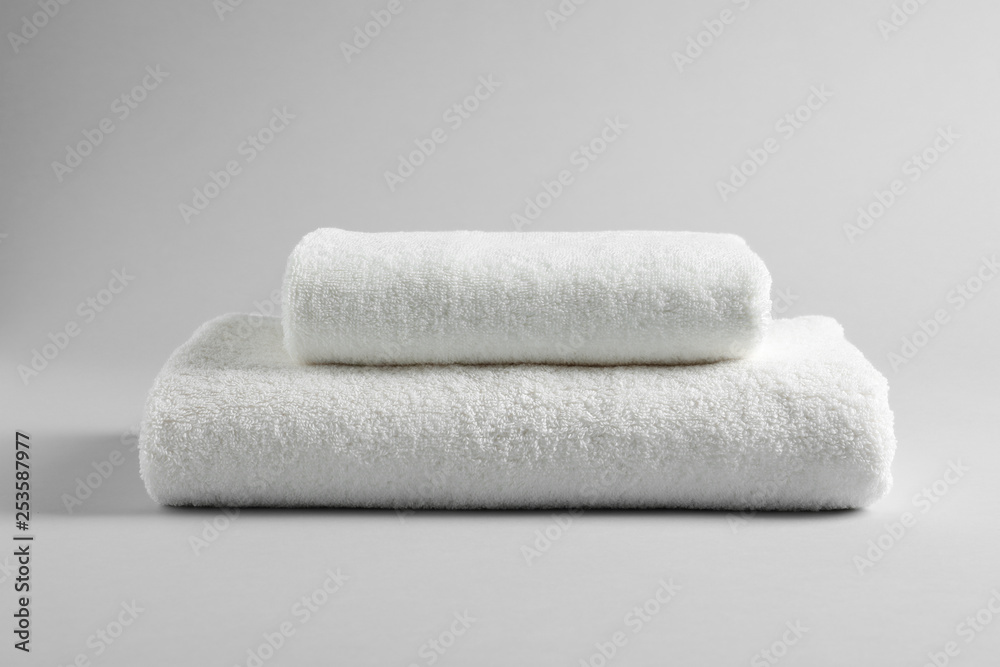 Fresh soft folded towels on light background Fresh soft folded towels on light background