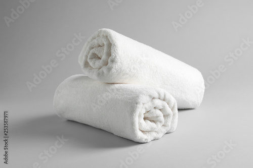 Fresh soft rolled towels on light background