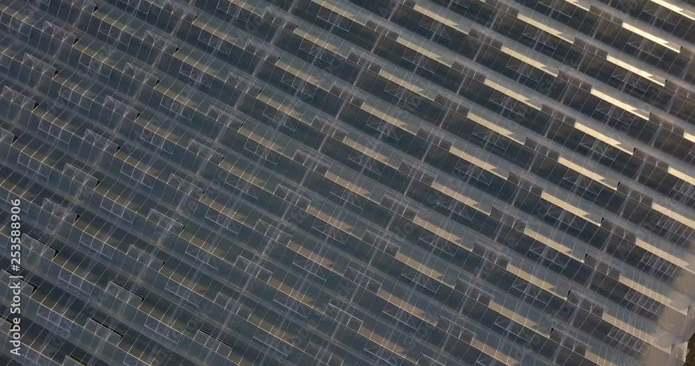 Top down aerial shot of the roof of a industrial greenhouse.