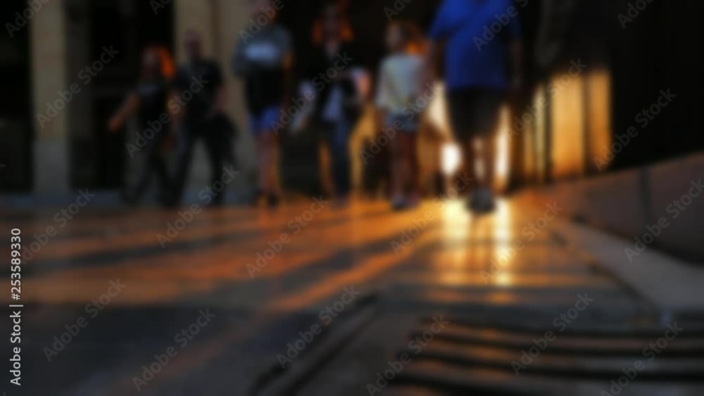 A low POV, beautifully blurred shot: people walking in a hallway or corridor, at dusk. A low POV, beautifully blurred shot: people walking in a hallway or corridor, at dusk.