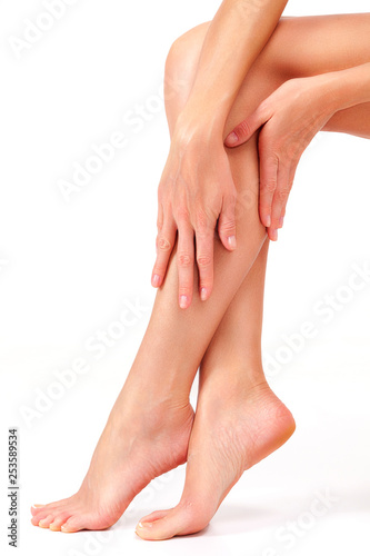 Beautiful long female legs, unwanted hair removal concept. Skin care. White background