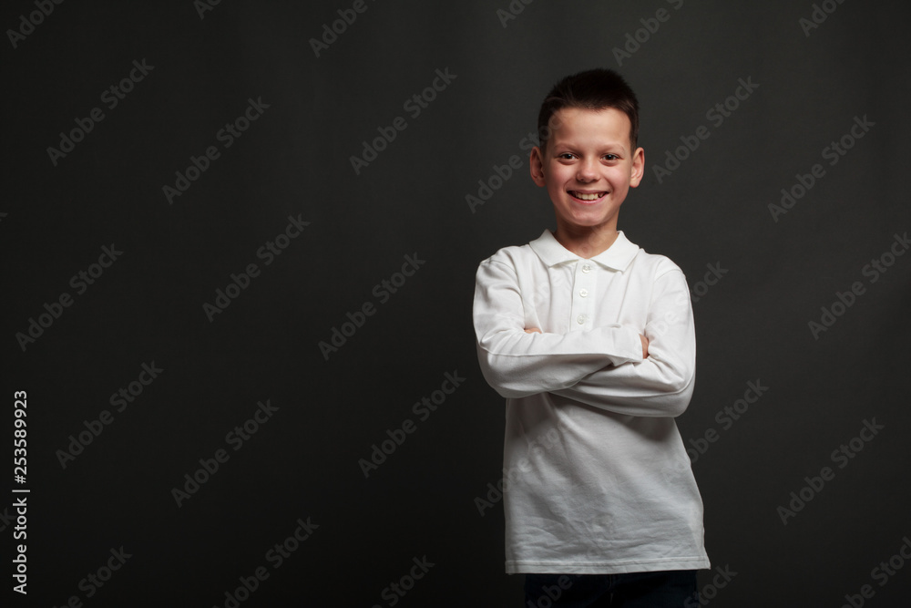 a model boy posing on gray background a model boy posing on gray background
