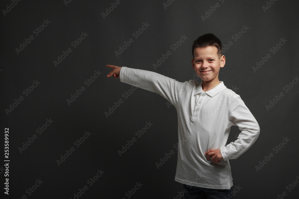 a model boy posing on gray background a model boy posing on gray background