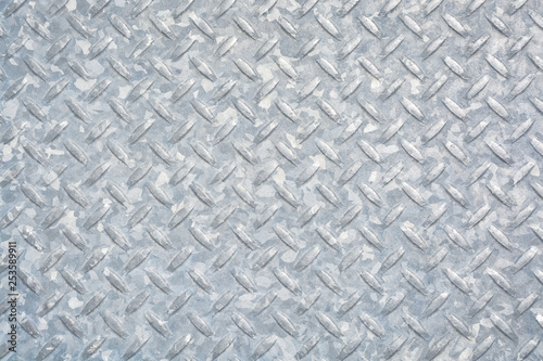 Checkered metal plate covered with zinc. Grundy metal texture background