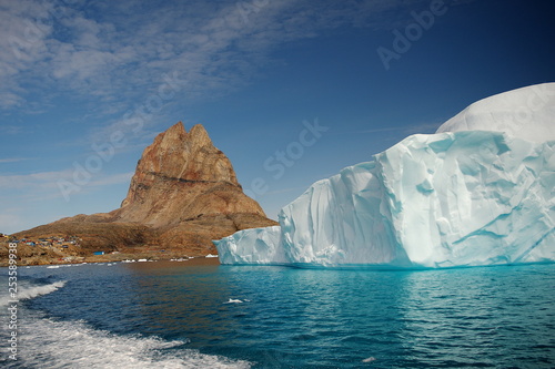 Iceberg  mountains  water  sky.