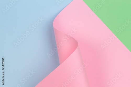 Abstract geometric pink paper shape on blue and green color paper background