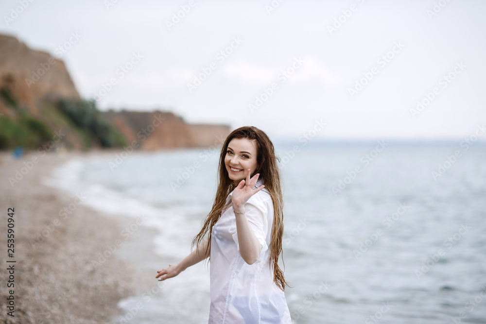 woman in white clothing refreshing at the seaside woman in white clothing refreshing at the seaside