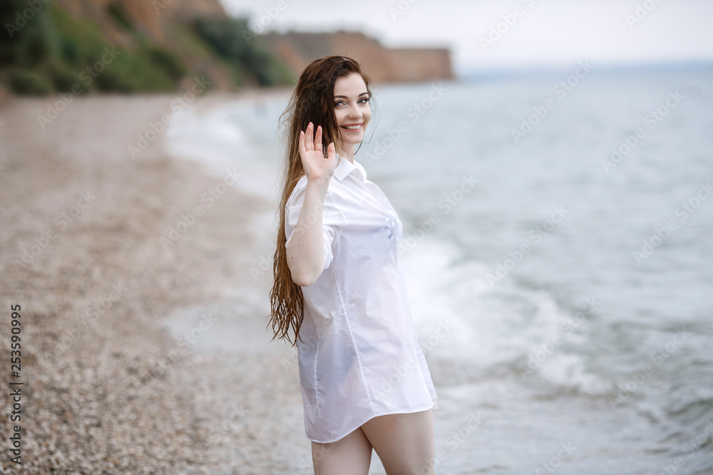 woman in white clothing refreshing at the seaside woman in white clothing refreshing at the seaside