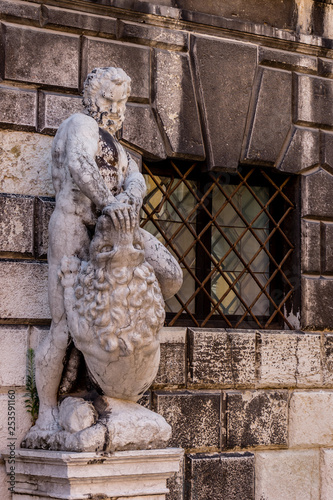 Italy, Venice, a statue in front of a brick building