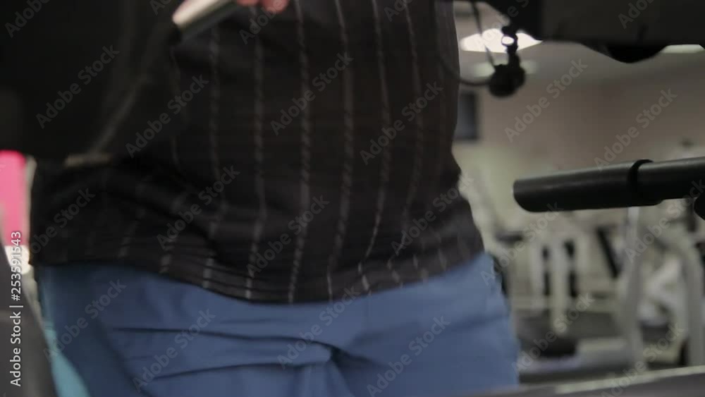 Fat man exercising on the treadmill in the gym. Fat man exercising on the treadmill in the gym.