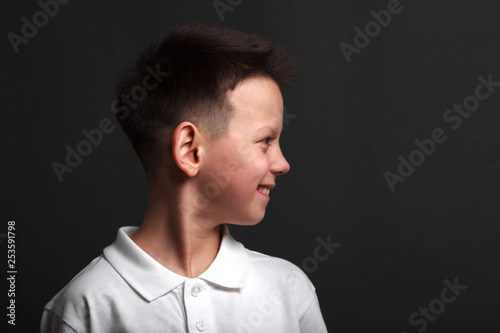 a model boy posing on gray background