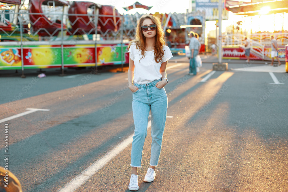 Women wearing t-shirt and jeans stays outdoor in the park - a Royalty Free  Stock Photo from Photocase