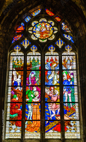 Joan of Arc scene on colorful stained glass window inside the Cathedral of the Holy Cross