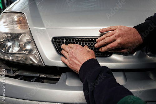 Car body work auto repair. Mechanic in garage.