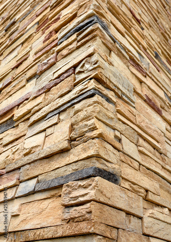 фотографія Corner of hew stone walls. Cut stone rustication texture
