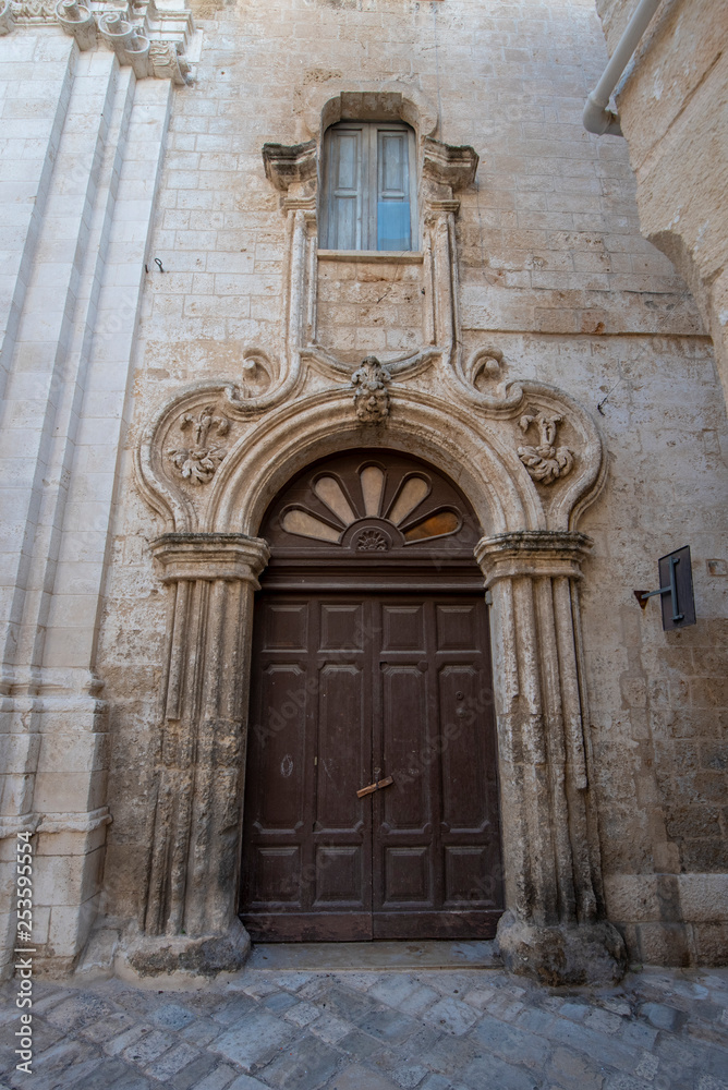 Monopoli, Puglia, Italy - View of street in Monopoli, Apulia. Italian spirit of southern Italy. Beautiful baroque door	