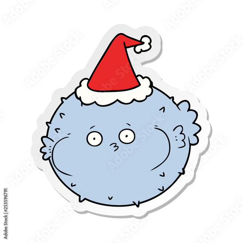 sticker cartoon of a puffer fish wearing santa hat