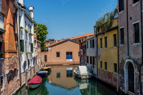 Italy, Venice, a boat that is sitting on the side of a building © SkandaRamana