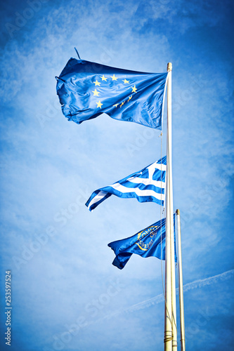 Flags , EU, Greece waving in the wind against the sky