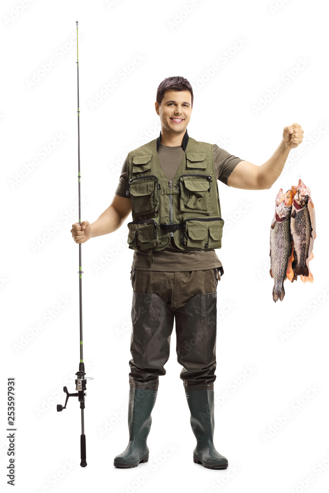 Young fisherman posing with a fishing rod and fish - obrazy, fototapety, plakaty 