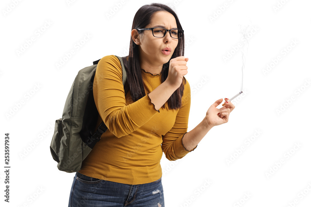 Young female student smoking a cigarette and coughing Young female student smoking a cigarette and coughing