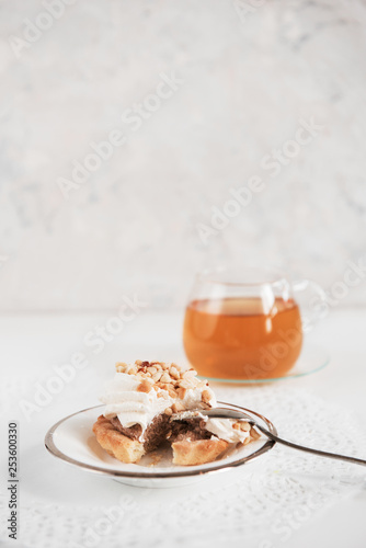 Cakes with tea on white bac...